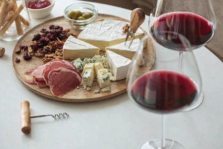 Calici di vino e assaggi di prodotti tipici calabresi su tagliere